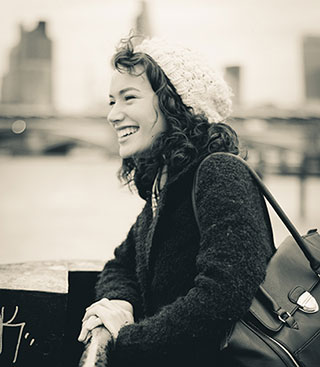 black and white photo of a smiling woman who is happy she can play piano