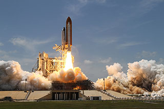 photo of a rocket launching from the ground of Earth and into space